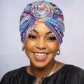 Close-up of vibrant floral turban with a stylish rose knot detail in ethnic print - Blue