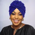 Detail of elegant dark blue turban hat featuring a handcrafted knit flower knot design - One Size / Sapphire Blue