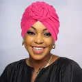 Close-up of vibrant rose red turban hat with oversized handmade 3D floral twist detail - One Size / Rose Red