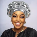 Detail of metallic silver braided turban cap showing luxury woven texture on African model - Gray