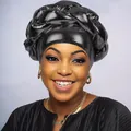 Front view of a shiny black braided turban headwrap with a metallic finish for women - Black