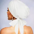 Detail view of the elegant oversized bow knot on a breathable white stretch turban hat - White