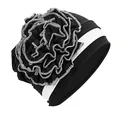 Close-up of contrast black and white turban hat with large side flower and stitching detail - One Size / Black with White Edge