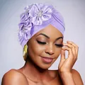 Detail of purple turban cap featuring 3D satin flowers, rhinestones, and black mesh veil - Light Purple