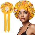 Detail of yellow floral satin sleep bonnet featuring a large bow and long adjustable straps - Single Layer / Yellow Floral