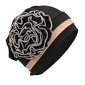 Detail view of the black turban cap with a large side flower and pink color block - One Size / Black Khaki Border