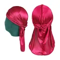 Rose red silky durag with braided band and long tail shown on a green mannequin - Burgundy