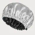 Detail showing dual-layer satin sleep bonnet with adjustable elastic band and silver grey finish - Grey + Black