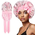 Close-up of pink floral satin bonnet with large bow and elastic strap details - Double Layer / Pink Print