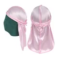 Detailed view of pink silky durag with braided straps and polished satin texture - Pink