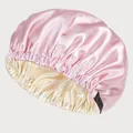 Detail of pink and champagne satin sleep cap showing the adjustable buckle and elastic band - Pink + Beige
