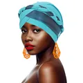 Close-up of turquoise braided turban hat with metallic fabric and orange earrings - Cyan