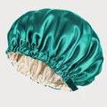 Detail of adjustable strap and buckle on a double-layer green satin bonnet - Teal And Beige
