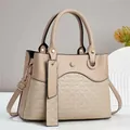 Detailed view of beige faux leather handbag with braided texture and gold hardware - Khaki