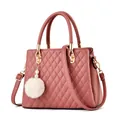 Dusty rose quilted handbag with dual handles and a decorative white fur ball pendant - Pink