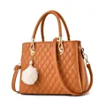 Caramel quilted faux leather handbag with white faux fur pompom and pearl charm accessory - Earthy Yellow