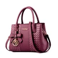 Elegant deep purple Boston handbag with textured synthetic leather and gold bow charm - Purple