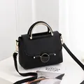 Minimalist black pebble leather handbag with gold metal handle and round buckle decoration - Black