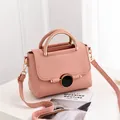 Pink lychee grain leather handbag with gold metal handle and adjustable strap - Pink