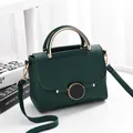 Dark green litchi grain shoulder bag with round metal buckle and curved handles - Verdant