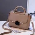 Khaki structured handbag with gold circular metal handle and pebble leather texture - Khaki