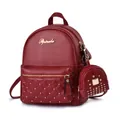Detail of dark red quilted leather backpack with gold rivets and matching coin purse - Burgundy