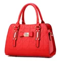 Elegant red structured handbag with geometric triangle quilting and bow detail - Red