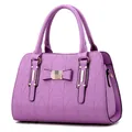 Elegant purple handbag with geometric triangle embossing and bow detail on top - Taro Purple