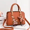 Brown leather handbag with floral embroidery and butterfly charm for women - Earthy Yellow