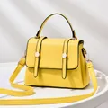 Bright yellow fashion crossbody bag with top handle and gold-tone metal hardware - Yellow