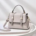 Minimalist beige crossbody small square bag with top handle and gold hardware detail - Off White