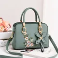 Sage green embroidered square crossbody bag with floral patterns and butterfly charm - Mint Green