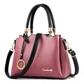 Elegant dusty rose large shoulder bag with black handles and gold logo details - Pink