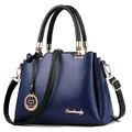 Deep blue luxury handbag with black handles and gold hardware details for women - Sapphire Blue