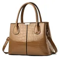 Deep brown crocodile embossed glossy tote bag with dual handles and long shoulder strap - Gold