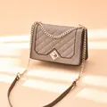 Quilted crossbody bag in apricot leather finish with gold chain and metal buckle - Khaki
