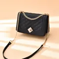 Chic black quilted crossbody bag with gold diamond clasp and chain strap detail - Black