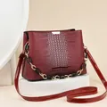 Elegant wine red bucket bag with crocodile texture and dual shoulder straps - Burgundy