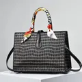 Detail of black crocodile texture handbag with golden buckle and colorful silk scarf wrap - Black