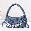 Modern light blue pleated woven handbag with chunky silver chain and crossbody strap - Blue