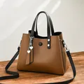 Fashionable brown PU leather tote bag with black handles and heart charm details - Coffee