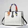 Detail of embossed crocodile pattern on white leather bag with decorative silk scarf handle - Off White