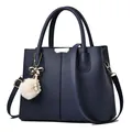 Navy blue lychee grain leather handbag with plush ball pearl charm and golden hardware - Royal Blue
