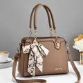 Brown lychee texture handbag with gold chain handles and scarf on a table - 29*12*21cm / Khaki