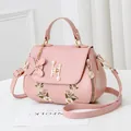 Pink faux leather handbag with floral embroidery, H-shaped pearl clasp and charm - Pink
