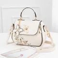 Chic beige PU leather handbag with floral embroidery and pearl lock detail - White (Single Sided Flower)