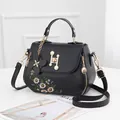 Elegant black PU shoulder bag with daisy embroidery and golden H-shaped pearl lock - Black (Single Sided Flower)