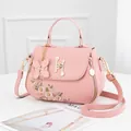 Pink PU leather handbag with daisy embroidery and pearl H-lock in variant view - Pink (Single Sided Flower)