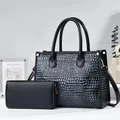 Detail of black faux leather tote with crocodile texture and matching long wallet - Blue