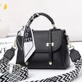 Elegant black lychee leather handbag with silk scarf and geometric wide strap - Black